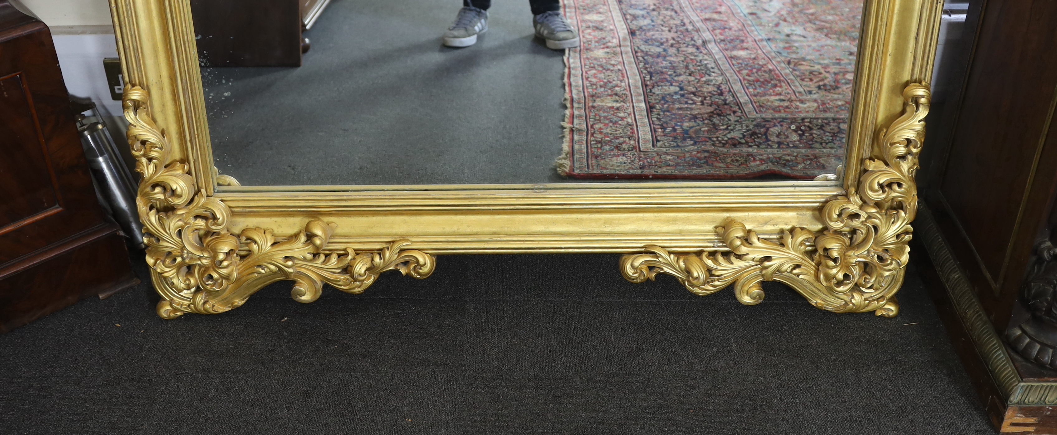 An ornate early 20th century carved giltwood wall mirror, width 146cm, height 250cm